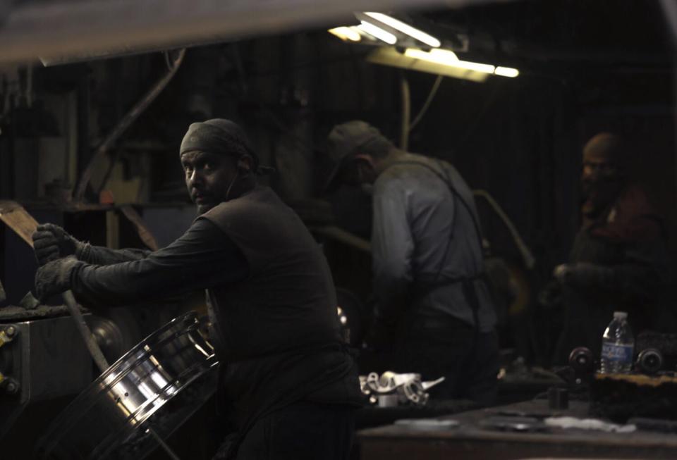 Workers polish wheel rims at Durangos Polishing along 108th Street in Watts