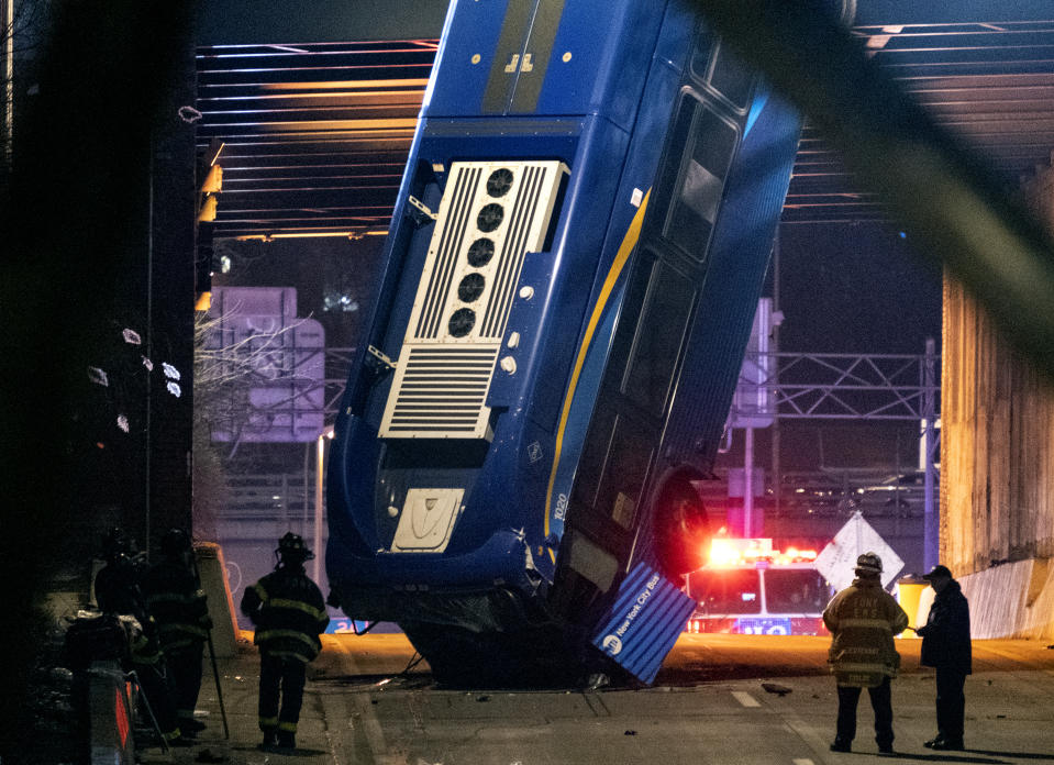A bus in New York City which careened off a road in the Bronx neighborhood of New York and is left dangling from an overpass Friday, Jan. 15, 2021, after a crash late Thursday that left the driver in serious condition, police said. (AP Photo/Craig Ruttle)