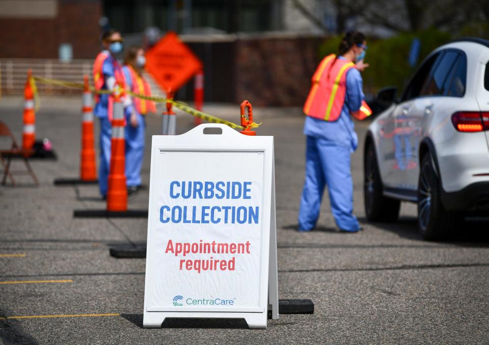 Patients are checked in and directed to the next stop at the curbside collection facility Wednesday, May 6, 2020, at St. Cloud Hospital. 
