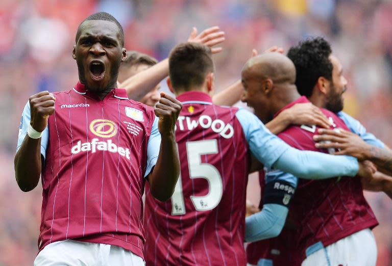 Aston Villa striker Christian Benteke (L) celebrates Villa's second goal during the FA Cup semi-final against Liverpool at Wembley stadium on April 19, 2015