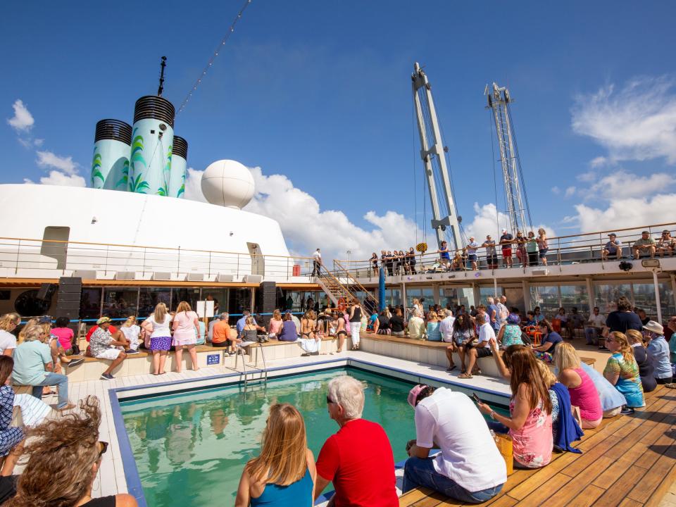 People sitting outside around a pool.