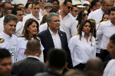 Colombia's President Ivan Duque walks next to with his wife, Maria Juliana Ruiz and the Colombian Vice President, Marta Lucia Ramirez during a rally against violence, following a car bomb explosion, in Bogota, Colombia January 20, 2019. REUTERS/Luisa Gonzalez