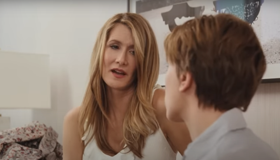 Woman and boy in a close conversation indoors, emotional expressions on their faces