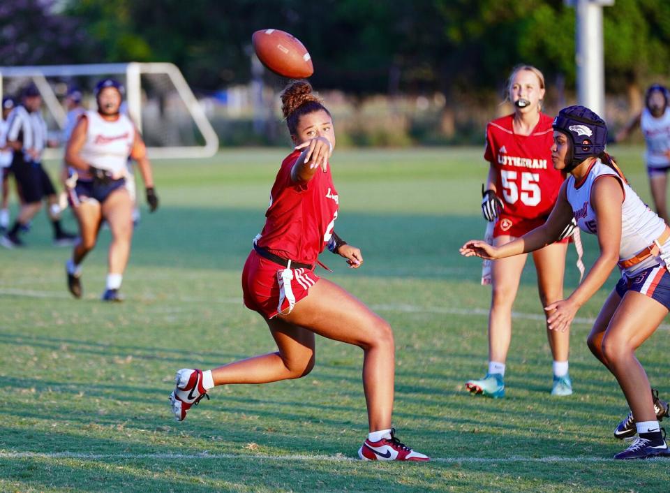 Orange Lutheran quarterback Makena Cook laterals the ball during a game against Eastvale Roosevelt.