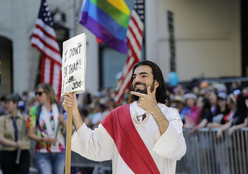 A man dressed as Jesus marches during the 45th annual Seattle Pride Parade Sunday, June 30, 2019, in Seattle. The parade commemorated both the first "gay liberation week" in Seattle in 1974 and the 50th anniversary of the Stonewall uprising, a police raid that sparked the modern-day gay rights movement. (AP Photo/Elaine Thompson)