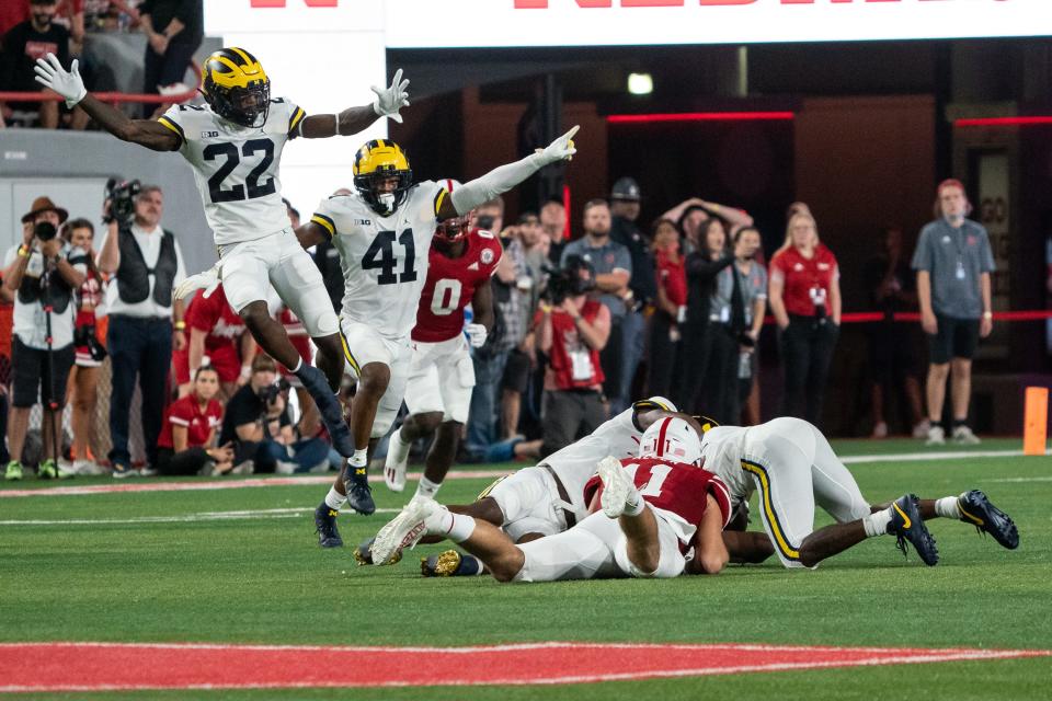 Michigan Wolverines defensive back Gemon Green and linebacker Nikhai Hill-Green celebrate after the Wolverines intercepted a pass from Nebraska Cornhuskers quarterback Adrian Martinez during the second quarter at Memorial Stadium.