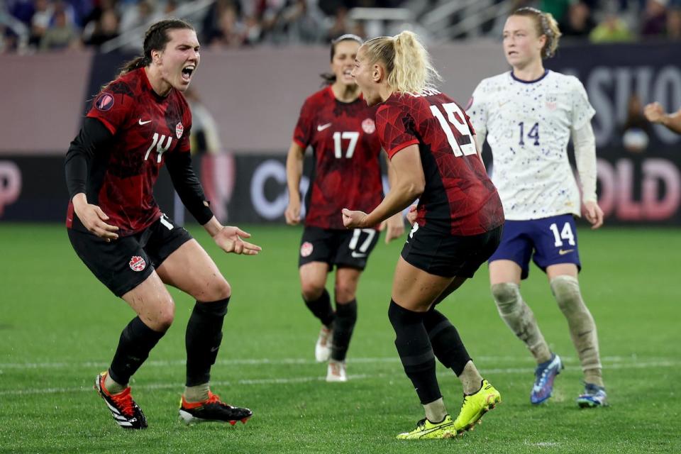 Vanessa Gilles, left, and Adriana Leon, right, celebrate Leon's extra-time goal that tied their semifinal with the U.S. at the Women's Gold Cup in March. The U.S. won in a shootout. (Getty Images - image credit)