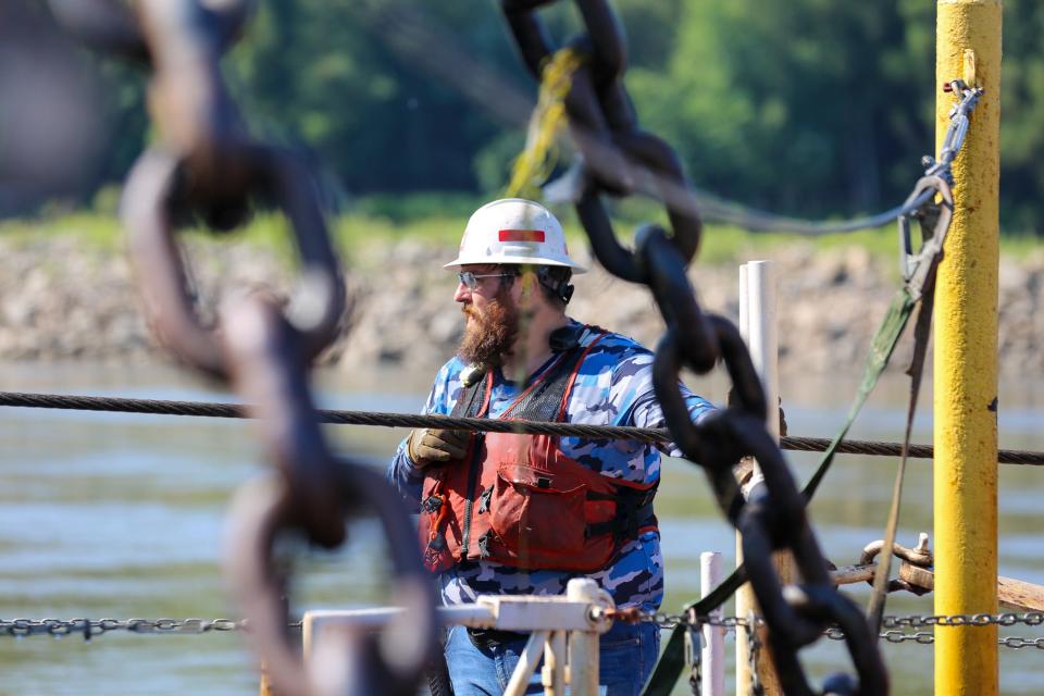 A worker prepares to check equipment aboard the Dredge Potter, a U.S. Army Corps of Engineers vessel working to maintain the Mississippi River shipping channel.