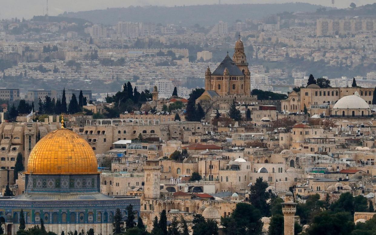 A picture taken on January 15, 2021 shows the The Dome of the Rock (L), in the Al-Aqsa mosques compound and the Abbey of the Dormition (C) on Mount Zion, a Benedictine Basilica, built over the site where Virgin Mary is said to have fallen asleep for the last time, in Jerusalem's Old City.  - AHMAD GHARABLI/AFP via Getty Images