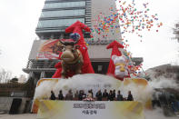 South Korean financial officers celebrate the opening of this year's trading in Seoul, South Korea, Thursday, Jan. 2, 2020. Asian shares were mostly higher on optimism about a U.S.-China trade deal as most of the region's markets opened the new year's first day of trading Thursday. (AP Photo/Ahn Young-joon)