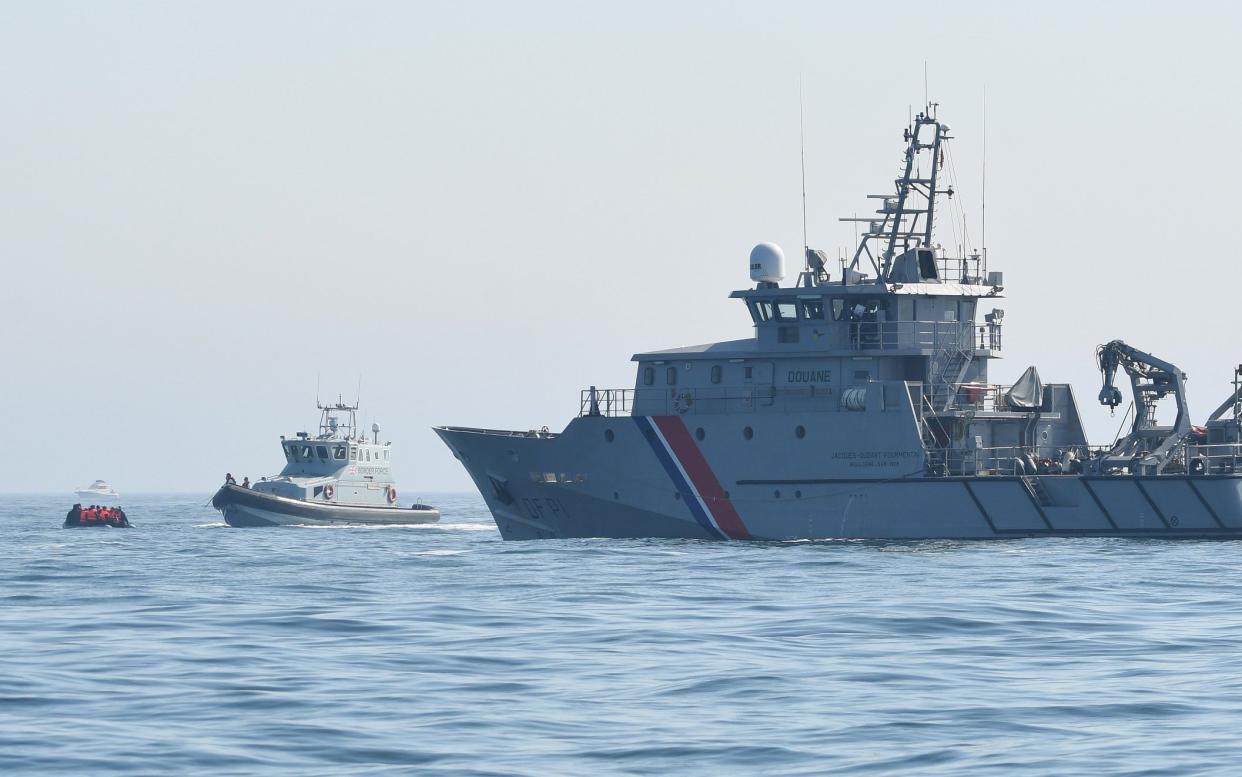 A small migrant boat accompanied by a Border Force vessel and a French Navy ship in the Channel - Steve Finn