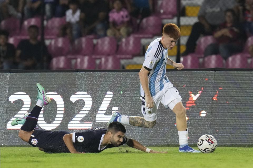 Valentin Barco, de Argentina, controla el balón mientras Leonardo Rivas, quien lo perseguía, cae, durante el Preolímpico Sudamericano Sub 23, en el estadio Misael Delgado, en Valencia, Venezuela, el domingo 21 de enero de 2024. (AP Foto/Ariana Cubillos)