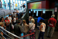 People wait in line to buy bus tickets at a bus station in Caracas, Venezuela May 21, 2018. Picture taken May 21, 2018. REUTERS/Marco Bello