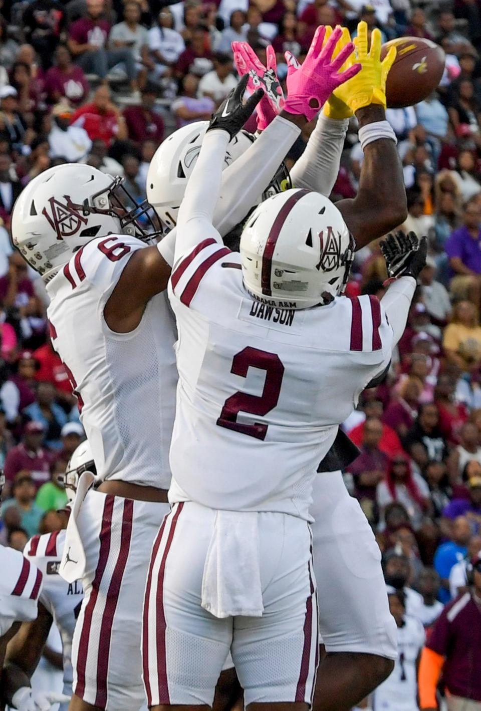 Alabama State Hornets wide receiver Kisean Johnson (1) catches a hail mary touchdown as time runs out in the first half against Alabama A&M safety Caleb Dawson (2) and safety Emari Pait (6) during the Magic City Classic at Legion Field in Birmingham, Ala., on Saturday October 28, 2023.