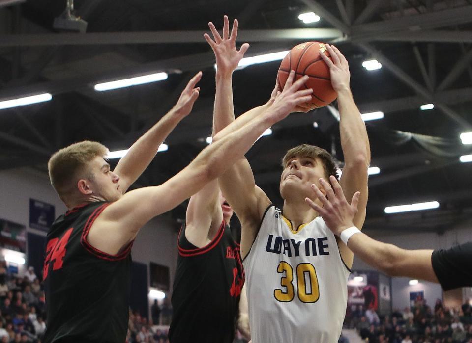 WayneÕs PJ Ostrowski (30) tries to get off a shot while surrounded by Glens Falls defenders during the state championship game at the Cool Insuring Arena in Glens Falls, New York March 16, 2024. Glens Falls won the game 50-37.