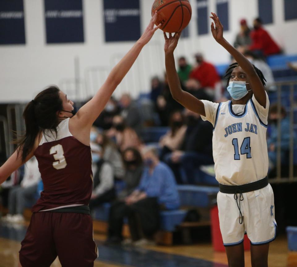 John Jay's Stephanie Jean-Baptiste takes a shot over Arlington's Julia Russo during Wednesday's game on January 19, 2022. 