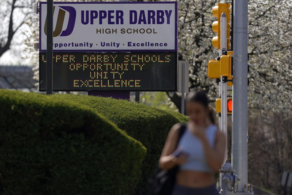 A student walks to class at Upper Darby High School, Wednesday, April 12, 2023, in Drexel Hill, Pa. For some schools, the pandemic allowed experimentation to try new schedules. Large school systems including Denver, Philadelphia and Anchorage, Alaska, have been looking into later start times.(AP Photo/Matt Slocum)