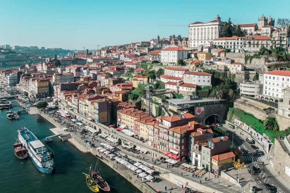 an aerial shot of Porto, showing buildings with red-shingled roofs