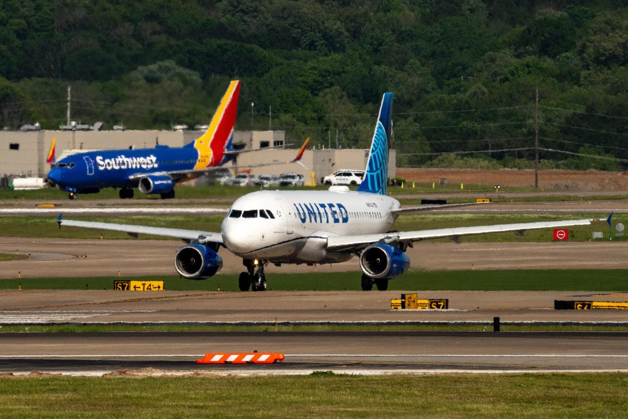 A United Airlines flight taxis in front of a Southwest Airlines flight at Nashville International Airport. State and local officials are hoping to convince the FAA to approve a longer runway that can handle flights to Asia.