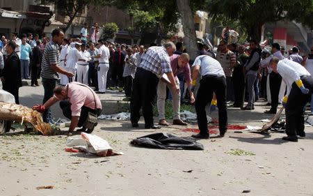 Forensic workers and policemen carry out investigations at the scene of a bomb blast in Cairo, September 21, 2014. REUTERS/Asmaa Waguih