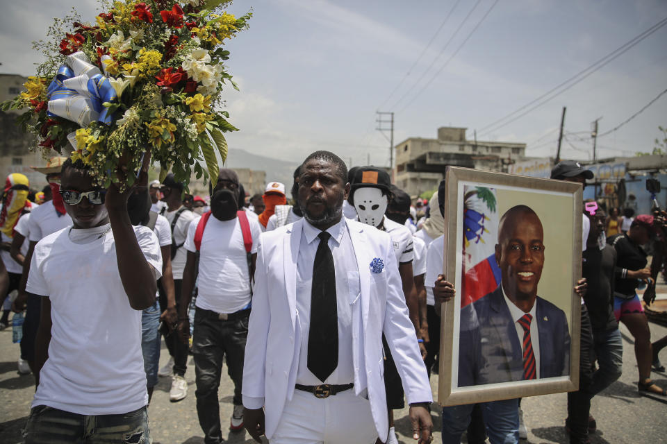 Jimmy Cherizier, alias Barbecue, a former police officer who heads a gang coalition known as "G9 Family and Allies," march during a rally to demand justice for slain Haitian President Jovenel Moise in Lower Delmas, a district of Port-au-Prince, Haiti Monday, July 26, 2021. Moise was assassinated on July 7 at his home. (AP Photo / Joseph Odelyn)