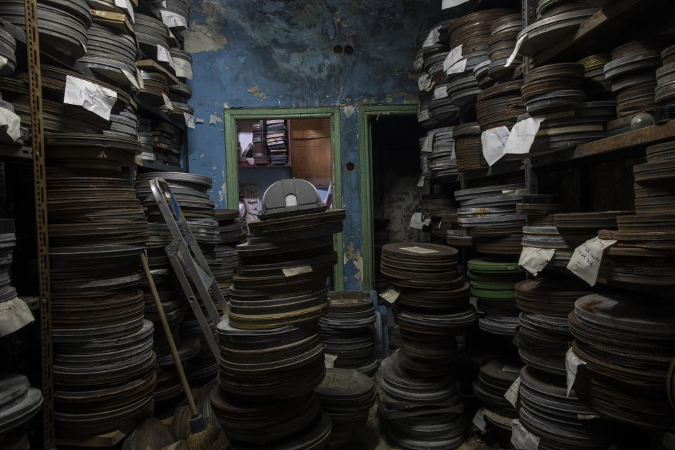 In this Friday May 29, 2020 film reels are stacked inside a warehouse at the Zephyros open-air cinema that specializes in films from past decades in Athens' central Petralona district. (AP Photo/Petros Giannakouris)