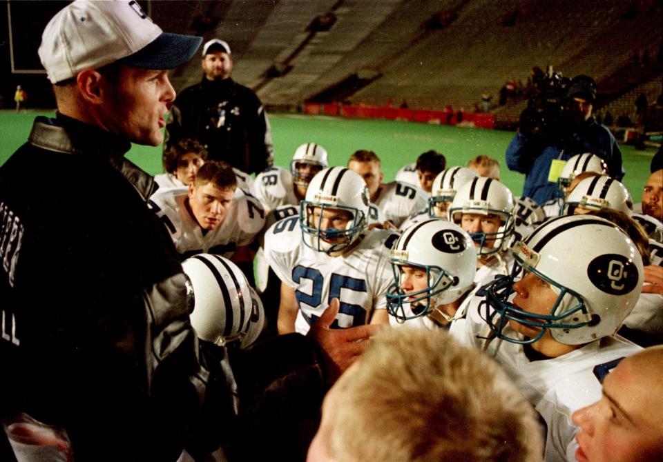 Oak Creek head coach Joe Koch talks with his team after falling just short in the 1997 championship game.