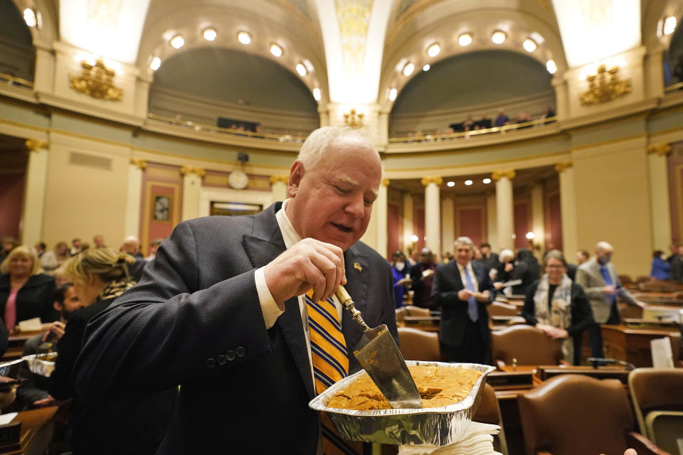 Minnesota Gov. Tim Walz delivers pumpkin bars to members of the house before the first day of the 2023 Legislative session, Tuesday, Jan. 3, 2023, in St. Paul, Minn. (AP Photo/Abbie Parr)