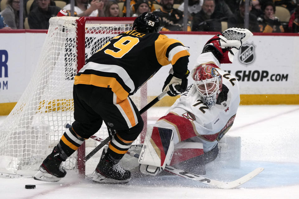 Pittsburgh Penguins' Jake Guentzel (59) can't get a shot past Florida Panthers goaltender Sergei Bobrovsky during the second period of an NHL hockey game in Pittsburgh, Friday, Jan. 26, 2024. (AP Photo/Gene J. Puskar)
