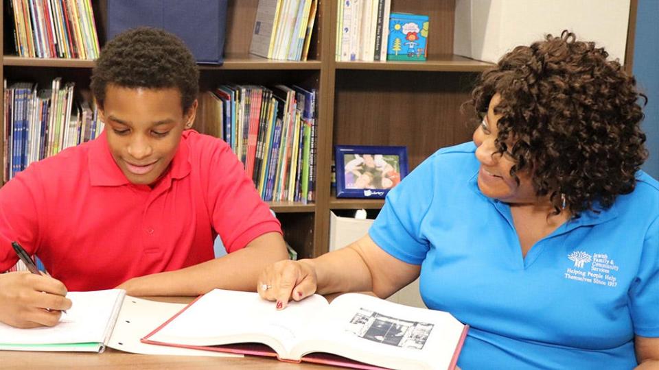 A student and mentor collaborate on academics in the Achiever's for Life program, part of The LJD Jewish Family & Community Services.