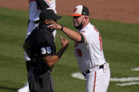 Baltimore Orioles manager Brandon Hyde, right, argues with home plate umpire Jeremie Rehak after the umpire ejected Hyde during the fourth inning of a baseball game, Thursday, April 8, 2021, on Opening Day in Baltimore. Hyde argued against a call on a pitch from Red Sox's Eduardo Rodriguez that hit Orioles' Rio Ruiz but wasn't awarded first base on a check swing strike. (AP Photo/Julio Cortez)