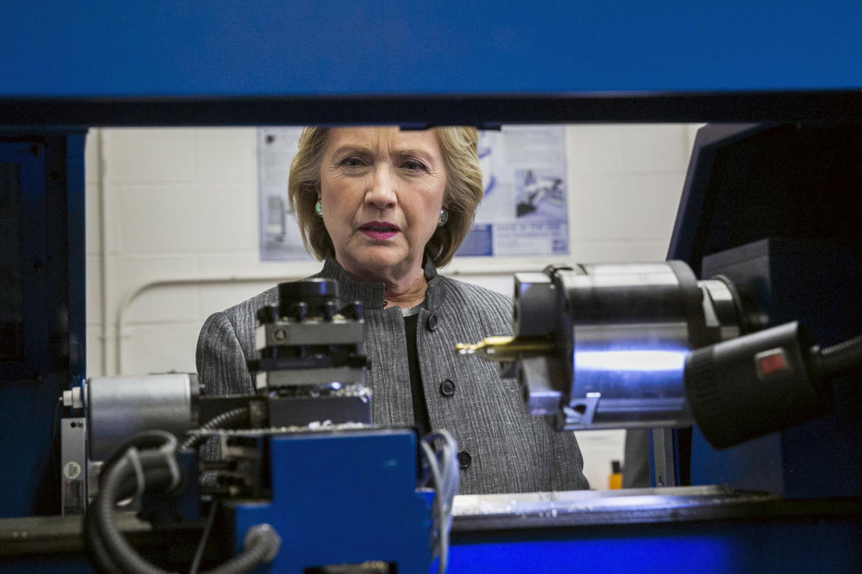 Then-U.S. presidential candidate and former Secretary of State Hillary Clinton inspects a robot CNC machine while touring the New Hampshire Technical Institute Community College in Concord, New Hampshire, April 21, 2015. REUTERS/Lucas Jackson