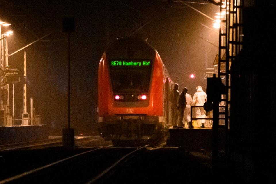 Forensics staff examine the train at Brokstedt station on Wednesday (AP)