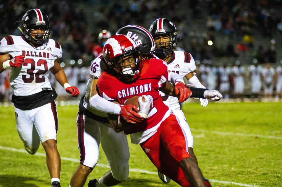 Manual High School running back Zah’Ron Washburn runs the ball during a football game against Ballard on Friday, Sept. 23, 2022, in Louisville, Ky. The Crimsons defeated the Bruins 21-0.