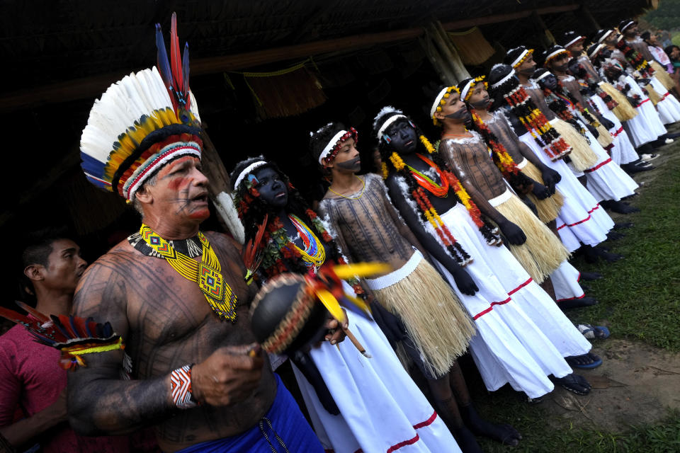 Chief Sergio Muti Tembe sings ritual songs with Indigenous girls and boys during the final ritual and most symbolic day of the Wyra'whaw coming-of-age festival at the Ramada ritual center, in the Tenetehar Wa Tembe village, located in the Alto Rio Guama Indigenous territory in Para state, Brazil, Sunday, June 11, 2023. (AP Photo/Eraldo Peres)