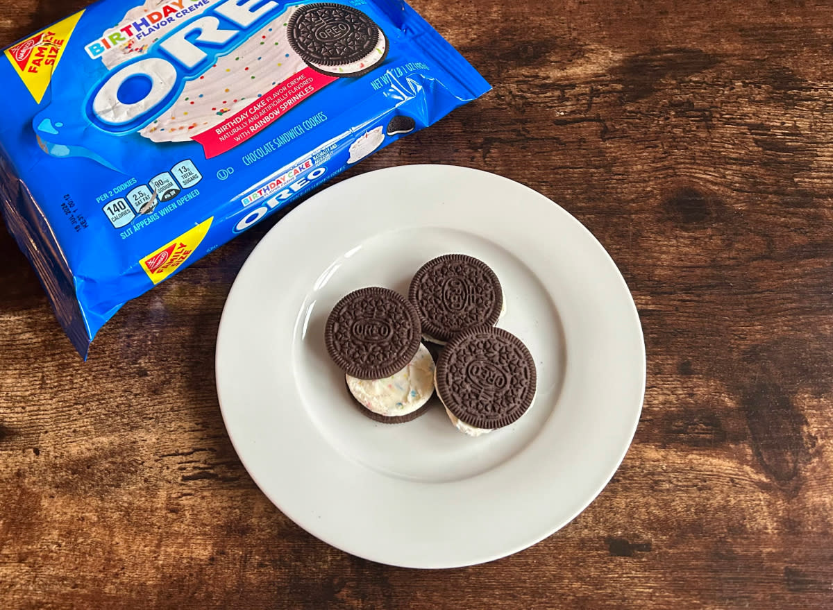 birthday cake flavor oreos on a plate next to a package of birthday cake flavor oreos