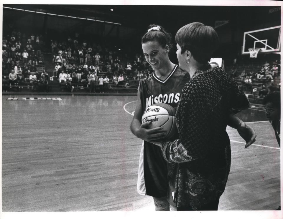 Barb Franke shares a joyous moment with coach Jane Albright-Dieterle after scoring her 1,000th point as a Badger in 1994.