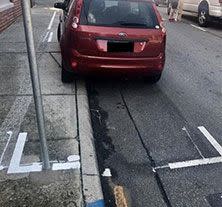 Ms Petrie shared an image of the car parked partly on the footpath online on Friday. Source: Facebook