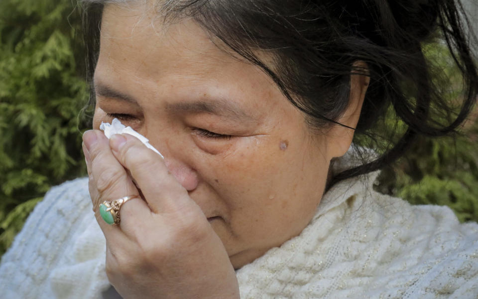 REMOVES REFERENCE TO HOMELESS KILLED - Choi Fung Lin wipes away tears following the funeral for Chuen Kok at the Ng Fook Funeral Home Friday Oct. 18, 2019, in New York. Lin, a Chinatown resident, knew Kok for 18 years and often checked on him after he started to "live in the streets" the past two years. Kwok, 83, was one of four men bludgeoned to death on Oct. 5. (AP Photo/Bebeto Matthews)