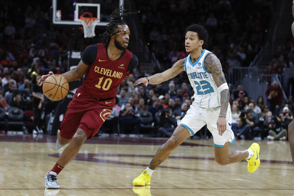 Cleveland Cavaliers guard Darius Garland (10) drives against Charlotte Hornets guard Tre Mann (23) during the first half of an NBA basketball game, Monday, March 25, 2024, in Cleveland. (AP Photo/Ron Schwane)