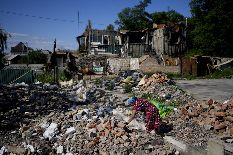 Melania works clearing the rubble of a temple that was destroyed during attacks in Gorenka, on the outskirts of Kyiv, Ukraine, Monday, June 6, 2022. (AP Photo/Natacha Pisarenko)