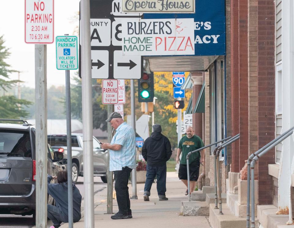 People are seen on South Adams Street in downtown New Lisbon, Wis.