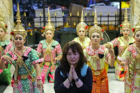 A tourist prays at Erawan Shrine, a Hindu shrine popular among tourists in central Bangkok, Thailand, October 16, 2017. Picture taken October 16, 2017. REUTERS/Athit Perawongmetha