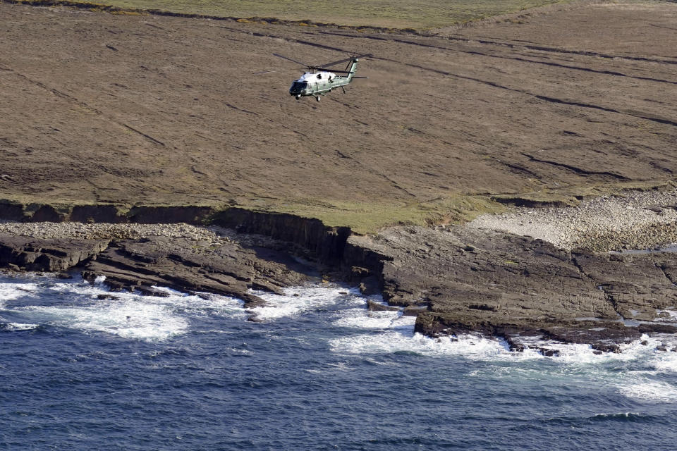 Marine One with President Joe Biden on board flies over the coast of Ireland as he travels to visit the North Mayo Heritage Center in County Mayo, Ireland, Friday, April 14, 2023. (AP Photo/Patrick Semansky)