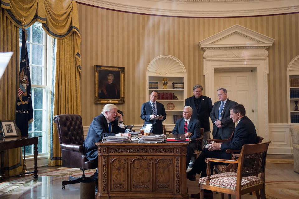 <p>JAN. 28, 2017 – President Donald Trump speaks on the phone with Russian President Vladimir Putin in the Oval Office of the White House in Washington, DC. Also pictured, from left, White House Chief of Staff Reince Priebus, Vice President Mike Pence, White House Chief Strategist Steve Bannon, Press Secretary Sean Spicer and National Security Advisor Michael Flynn. (Photo: Drew Angerer/Getty Images) </p>