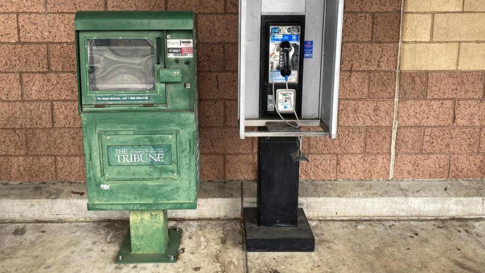 Two analog information delivery systems that are changing to digital, the print newspaper and landline pay phone at Food 4 Less in San Luis Obispo Feb. 14, 2024.