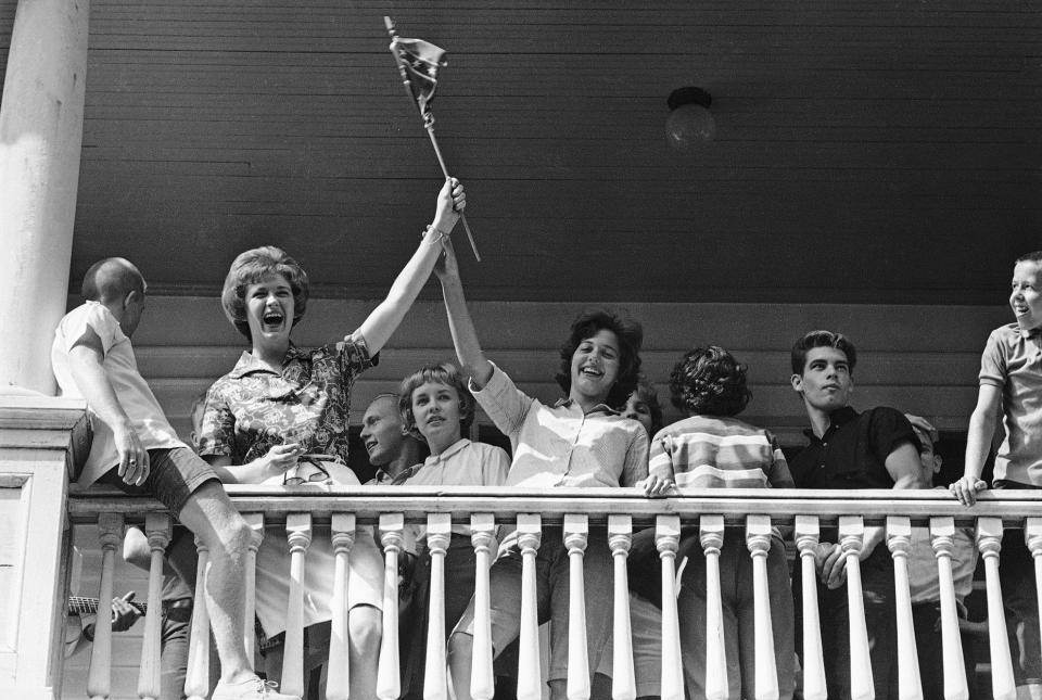 A group of high schoolers wave a Confederate flag and sing "Dixie" as they whoop it up on a porch in Tuskegee, Ala., Sept. 2, 1963 across the street from Tuskegee High School, which was scheduled to open on an integrated basis.