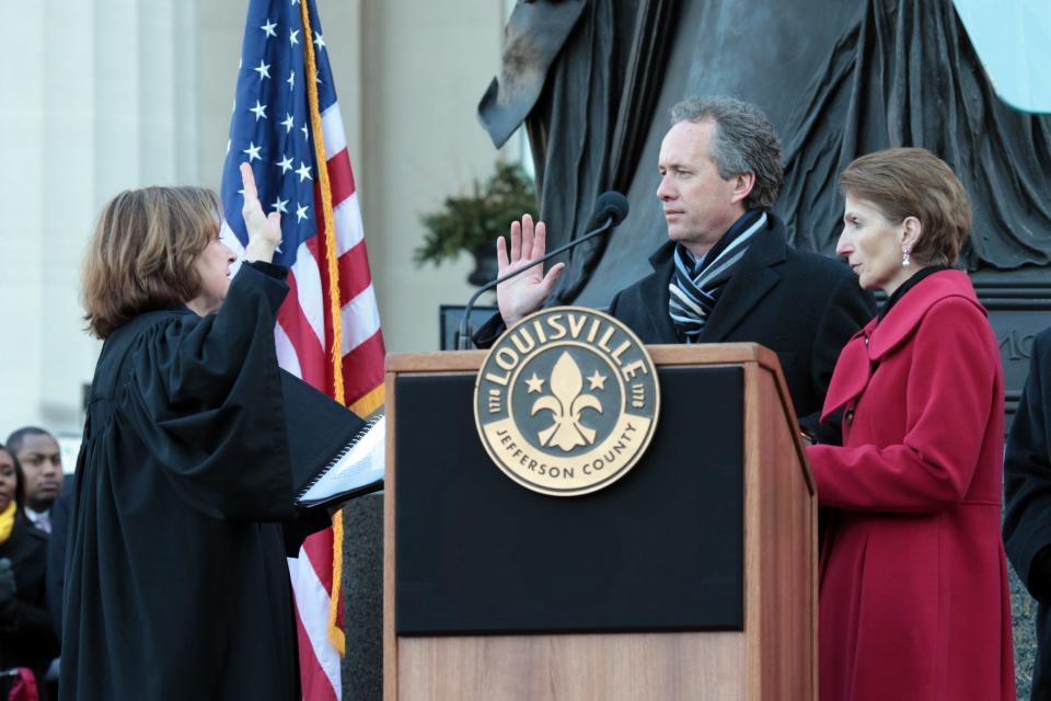 Greg Fischer is sworn in as mayor while his wife Alex watches outside Metro Hall during the inauguration ceremony on Jan. 3, 2011. (Photo by Angela Shoemaker, Special to the Courier-Journal)