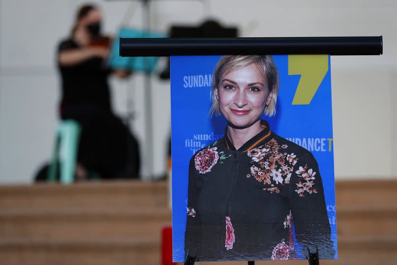 A musician plays a violin behind a photograph of cinematographer Halyna Hutchins during a vigil in her honour in Albuquerque, N.M., Oct. 23, 2021