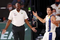 FILE - In this Aug. 10, 2020, file photo, Indiana Pacers head coach Nate McMillan and forward Doug McDermott (20) react to a call during the second half of an NBA basketball game against the Miami Heat, in Lake Buena Vista, Fla. The Indiana Pacers fired coach Nate McMillan on Wednesday, Aug. 26, 2020, less than three weeks after announcing he would keep the job for two more years. Team officials made the announcement 48 hours after the Pacers suffered their second straight first-round sweep. (Kim Klement/Pool Photo via AP, File)